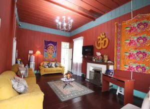 a living room with a child sitting on the floor at Pousada Shamballah Paranapiacaba in Paranapiacaba