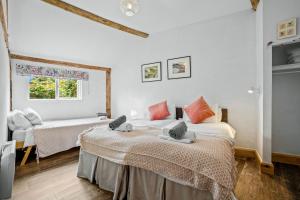 a bedroom with two beds and a window at Long Barn in Little Marcle