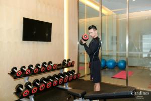 a man holding a red ball in a gym at Citadines Keqiao Shaoxing in Shaoxing