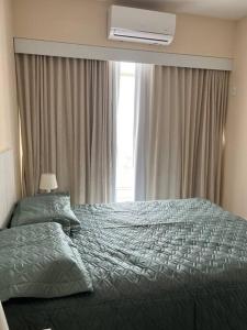 a bedroom with a large bed and a window at Está errado! App ruim in Rio de Janeiro