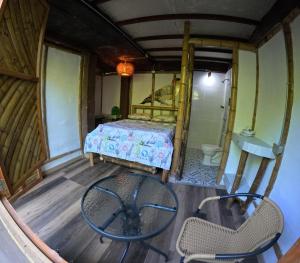a room with a bed and a table and chairs at Bio Coliving Tayrona, Eco Retreat for You or Your group with Fast, Reliable WiFi & Power in Nature in Santa Marta +70 photos