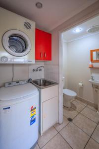 a small bathroom with a sink and a toilet at Villa Royale in Cairns North