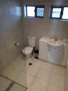 a bathroom with a toilet and a sink at Maroochy Sands Holiday Apartments in Maroochydore