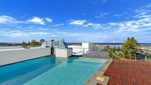 a swimming pool on the roof of a house at Coast Luxury Apartments 17 in The Entrance