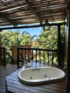 a bath tub sitting on top of a wooden deck at Ilha de Toque Toque Eco Boutique Hotel & Spa in Toque Toque Grande