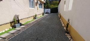 an alley between two buildings with plants on the side at Vila Zeus in Cristian