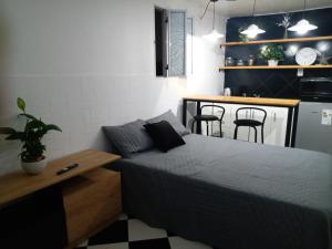 a bedroom with a bed and a kitchen with a table at Departamento monoambiente Belgrano R in Buenos Aires