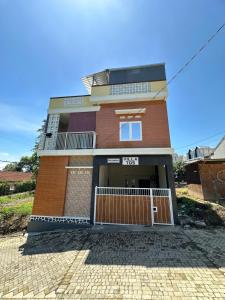 a brick building with a gate in front of it at Villa 705 Rooftop 3 Lantai Private Pool , 4 Bedroom & 4 Extra Bed in Tlekung