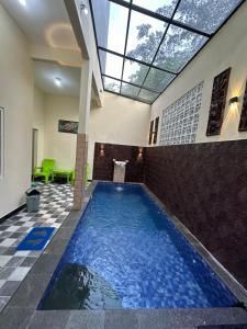 a large swimming pool in a building with a ceiling at Villa 705 Rooftop 3 Lantai Private Pool , 4 Bedroom & 4 Extra Bed in Tlekung
