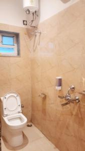 a bathroom with a toilet and a shower at Hotel Skyking in Gauripur