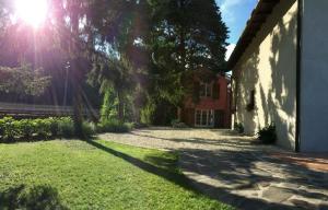 a house with the sun shining behind a tree at Agriturismo Terrarossa in Pistoia