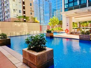 una piscina en una ciudad con edificios altos en Deluxe Queen 1BR Luxury Suite 11 - Pool, City View, en Manila