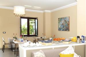 a dining room with a table with food on it at Meublé Leonetti in Palinuro