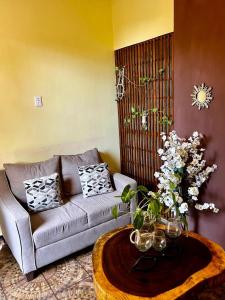a living room with a couch and a coffee table at Casa Guiba 1 puerto escondido in Puerto Escondido
