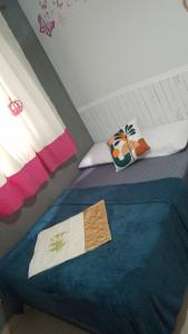a bedroom with two beds with towels on them at Castelo Di Palmas in Campo Grande