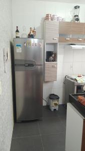 a kitchen with a stainless steel refrigerator in a kitchen at Castelo Di Palmas in Campo Grande