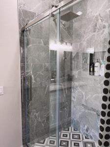 a shower with a glass door in a bathroom at Pool House Newly Remodeled 3bed 3bath Near DT Summerlin and Red Rock in Las Vegas