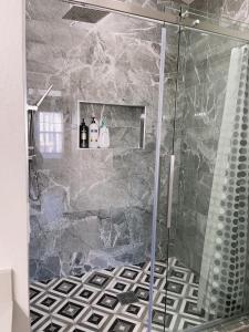 a bathroom with a shower with a glass door at Pool House Newly Remodeled 3bed 3bath Near DT Summerlin and Red Rock in Las Vegas +41 photos