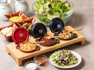 a table topped with bowls of food and a salad at APA Hotel Asakusabashi Ekikita in Tokyo +82 photos