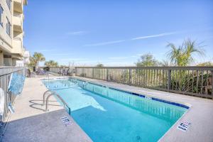 a swimming pool on a balcony with a fence at Oceanfront 3br/2ba Dog Friendly in Myrtle Beach