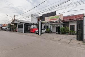an empty street in a town with cars parked outside at Urbanview Hotel Sunday Cirebon by RedDoorz in Cirebon