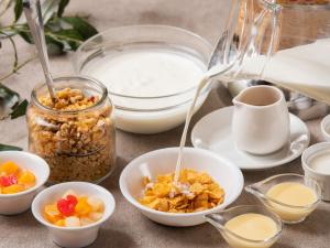 a table with bowls of cereal and other ingredients at APA Hotel Asakusabashi-Ekikita in Tokyo