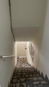 a hallway with a stairway with a white wall at apartamento entero en santa Gema interior 202 in Medellín