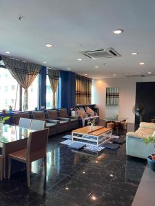 a large living room with couches and a table in it at Capsule Inn in Kota Kinabalu
