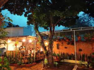 a group of people sitting at a restaurant at night at Homestay Vườn nhãn in Pleiku