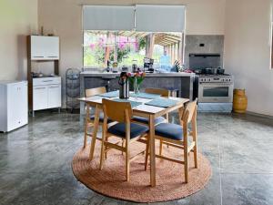 a kitchen with a wooden table with chairs and a kitchen with a stove at Loft Del Fundo Del Abuelo in Cajamarca