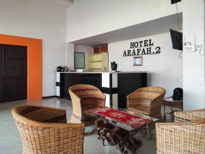 a room with a table and chairs and a counter at RedDoorz @ Arafah Hotel 2 Sungai Penuh Kerinci in Sungaitutung +24 photos