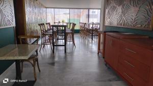 a dining room with chairs and a table and a bar at Habitaciones remodeladas con areas comunes in Momoxpan