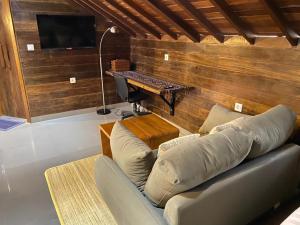 a living room with a couch and a piano at Alu Lofts in Seminyak