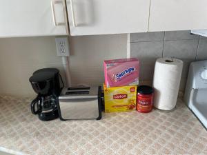 a counter top with a coffee maker and a box on it at Classic King Suite Apartment in Schenectady +6 photos