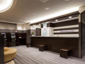 a lobby of a dental office with a counter and stool at Daiwa Roynet Hotel Mito in Mito
