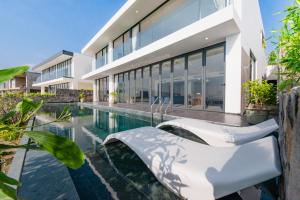 an exterior view of a house with a swimming pool at Promotion Early Booker Ocean Front Villa 500m2 with 4 bedrooms and swimming pool in Nha Trang