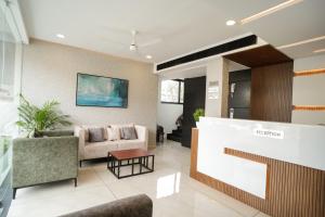 a lobby with a couch and a table at Sulu Residency in Ernakulam