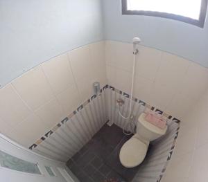 a small bathroom with a toilet in a staircase at Griya Rajawali Homestay Jogja in Kejayan +14 photos