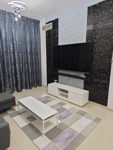 a living room with a flat screen tv on a wall at Ajman preal modren 1 bed room in Ajman 
