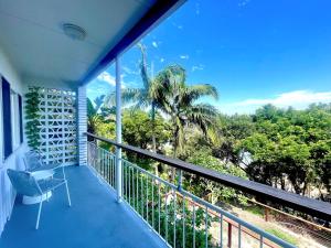 a balcony with a view of the ocean at Two Apartments Stray Leaves & The Jungle Room - 150m to Shaws Bay in East Ballina