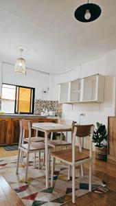 a kitchen with a table and chairs in a room at City Nest in Iloilo City