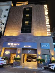 a building with a car garage with cars in it at DOAN STAY HOTEL in Ulsan