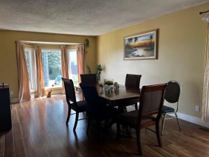 a dining room with a wooden table and chairs at Beddington masteroom close airport! in Calgary