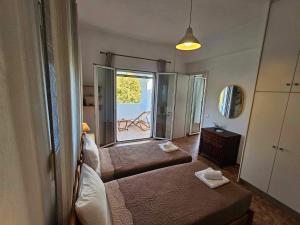 a room with a bed and a large window at The hidden villas in Kolios