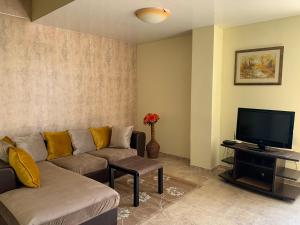 sala de estar con sofá y TV en Sea Apartments - Different Locations in Golden Sands, en Golden Sands