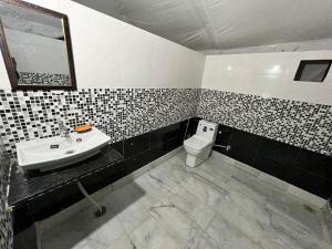 a bathroom with a sink and a toilet at Magic Heritage Camp & Resort in Jaisalmer