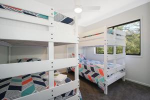 a bedroom with two bunk beds and a window at Always Bright - A Bright Escape in Bright