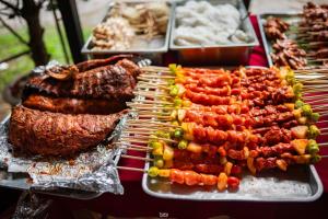 a bunch of different types of food on a grill at Siam Tara Resort Chiangkhong in Chiang Khong