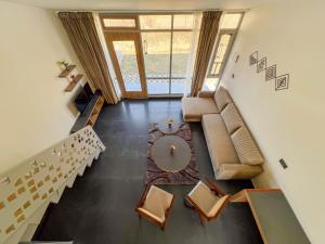 a living room with a couch and a table at Bir Valley Retreat in Bīr