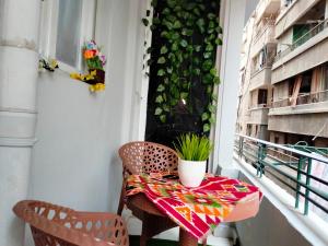 a small table on a balcony with a plant at Joy Homes in Cairo